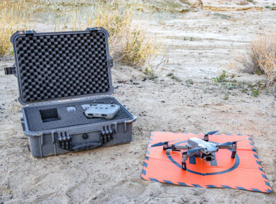 drone in the desert next to a hard case