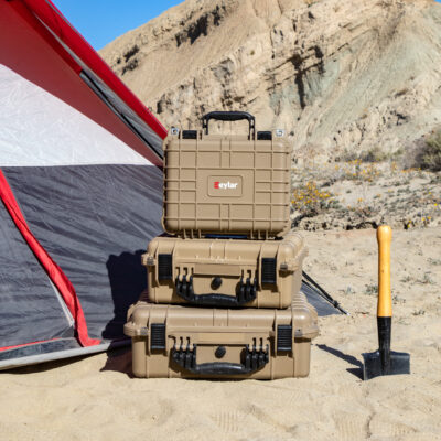 Eylar gear cases next to a tent in a camp