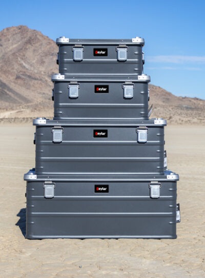 stack of black Eylar cases in the desert
